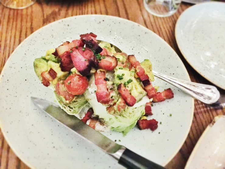 there is a salad on a white plate