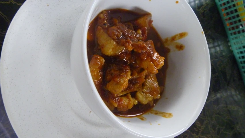 a small bowl filled with a meat stew