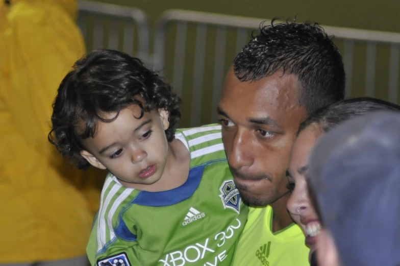 a young man and a  in green jerseys