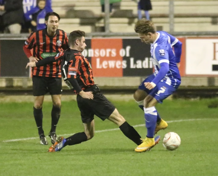 two young men playing soccer during a game