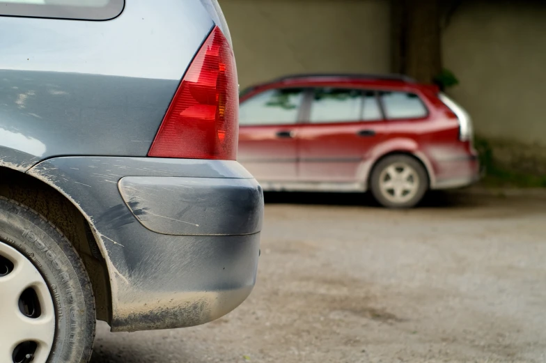 two cars parked in front of one another