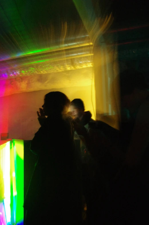 some people at a party with brightly colored lights