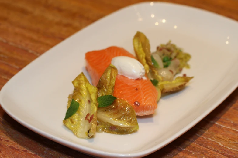 a very fancy meal on a plate at a restaurant