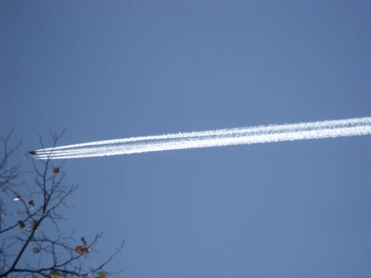 two jets in a blue sky leaving trails