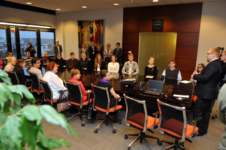 people are sitting and watching a seminar