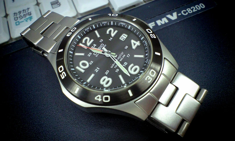 a close up of a watch sitting on a keyboard