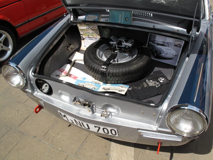 the back end of a car that is under a broken tire