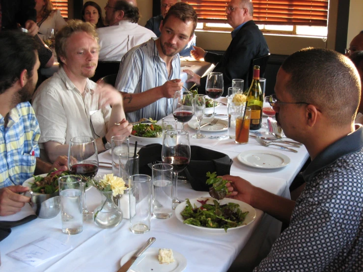 people sitting at the table talking to each other