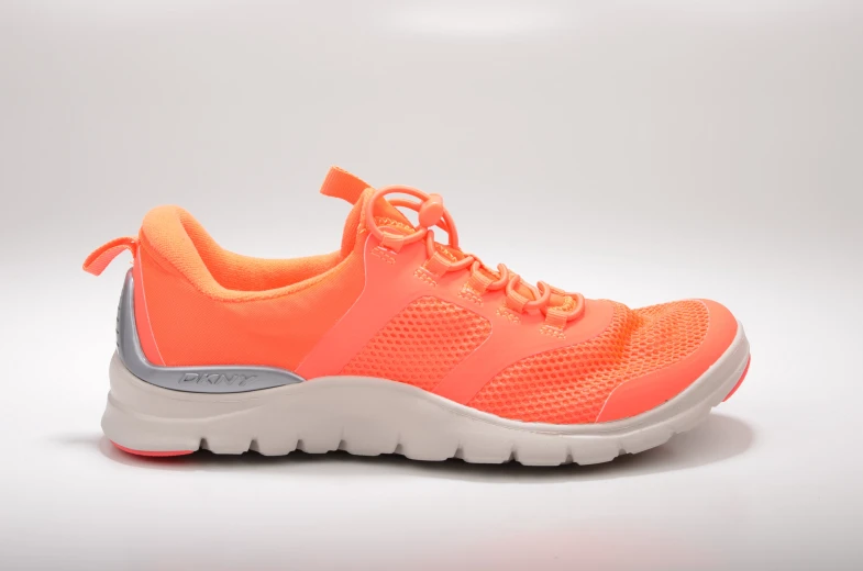 a bright orange shoe with a laces on the top