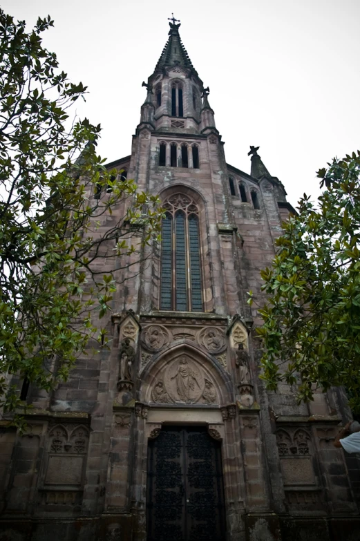 a large church has an elaborate tall clock tower