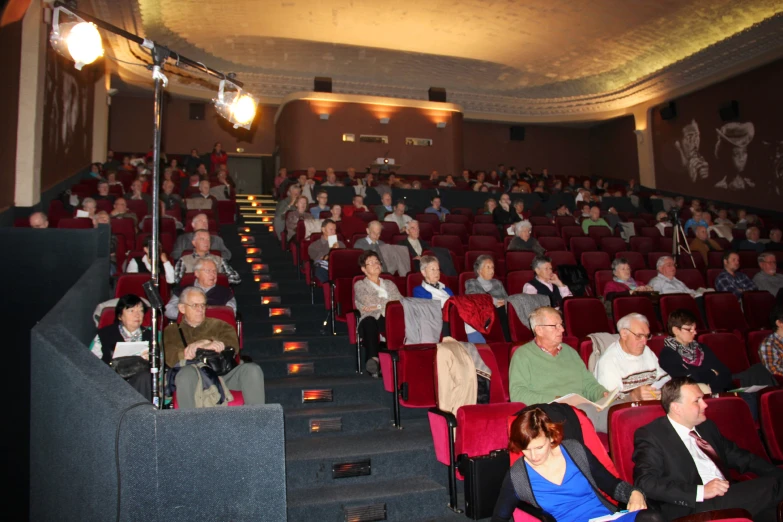 there are several people sitting in the auditorium