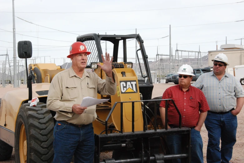 a man standing in front of a bulldozer talking