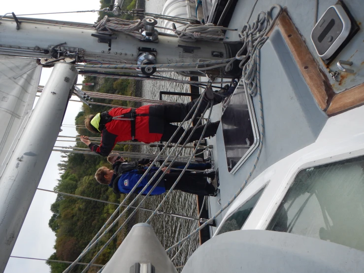 a group of people on a boat preparing to sail