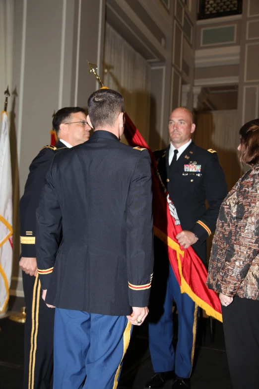 a man in a military uniform with other people