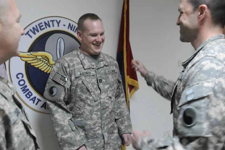 the soldier is greeting another soldier with his hands