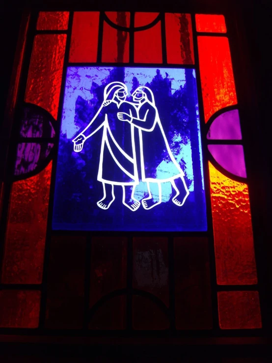 a colorful glass window with an image of two people