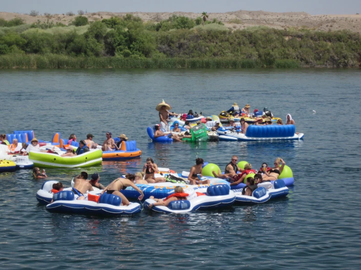 people enjoying a day at the lake on floating rafts