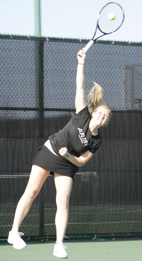 a woman is taking a swing at a tennis ball