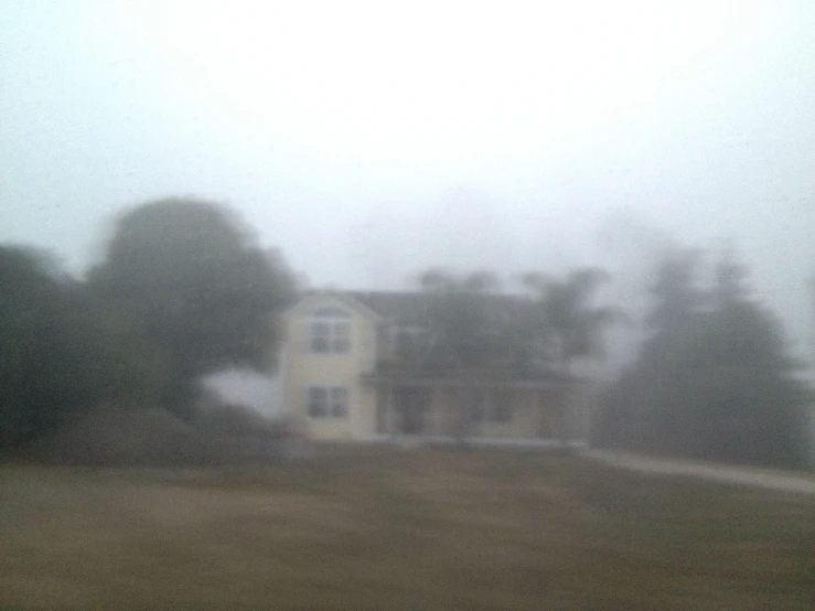the blurry image shows houses in the distance on an overcast day
