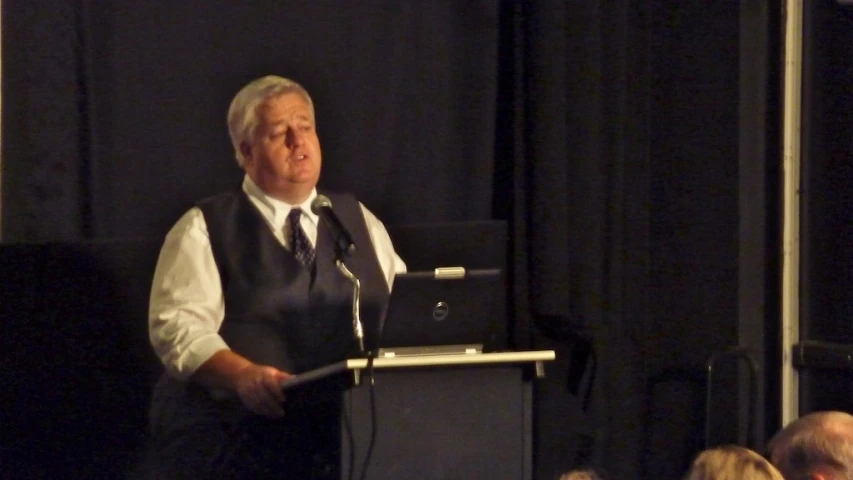 a man with grey hair and a tie