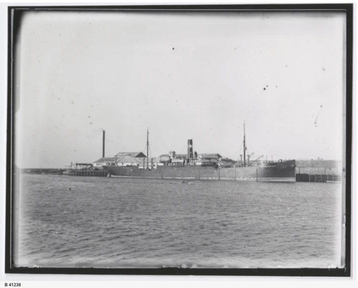 an old po of a big ship floating on the water