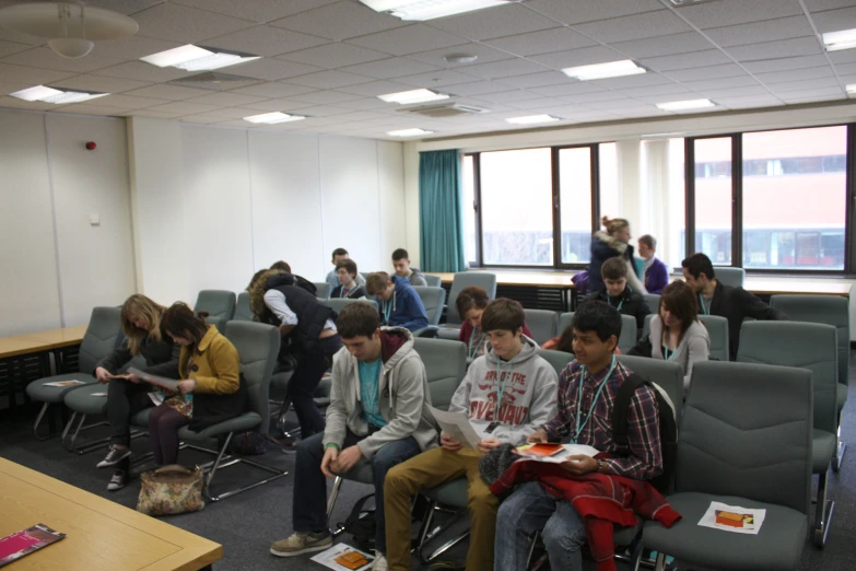 a group of people sitting in a lecture hall together