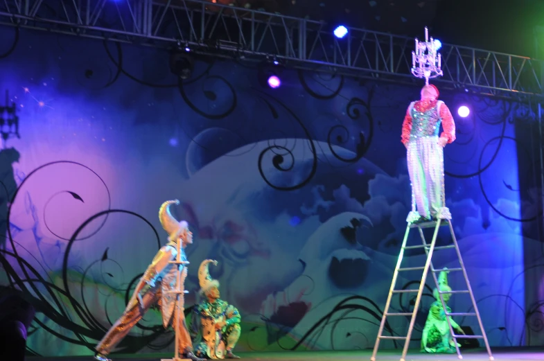 colorful puppet performers performing on a stage with colorful lighting