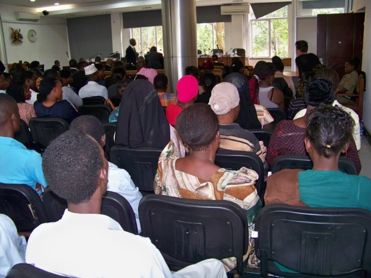 a group of people sitting in a room with microphones