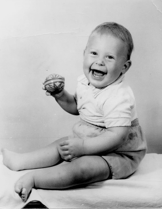 a very old picture of a laughing baby