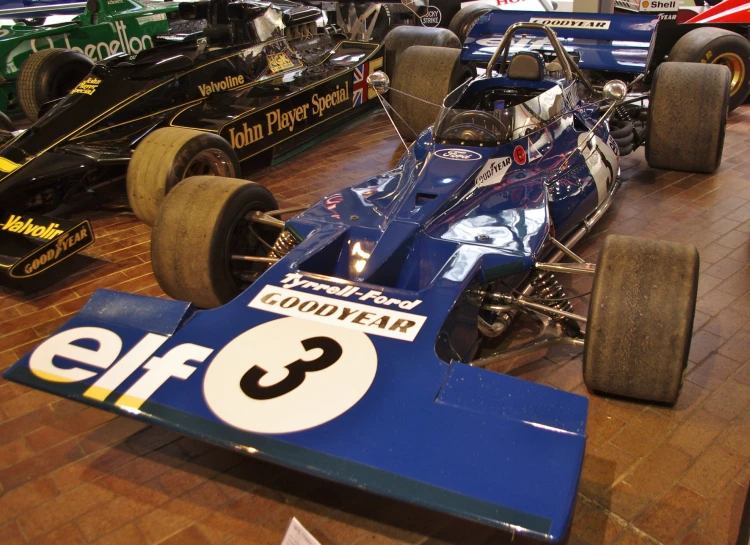 a line of race cars parked in a building