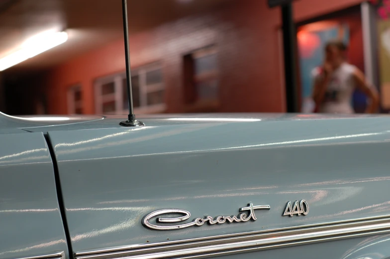 the emblem of an old blue car on display