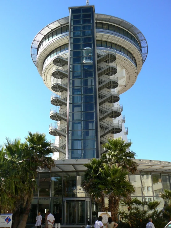 a modern looking building that is next to palm trees