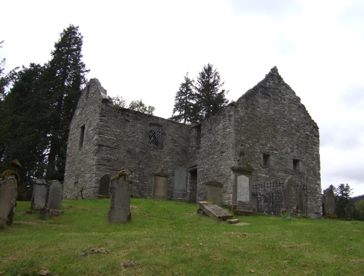 a large stone church with tombstones around it