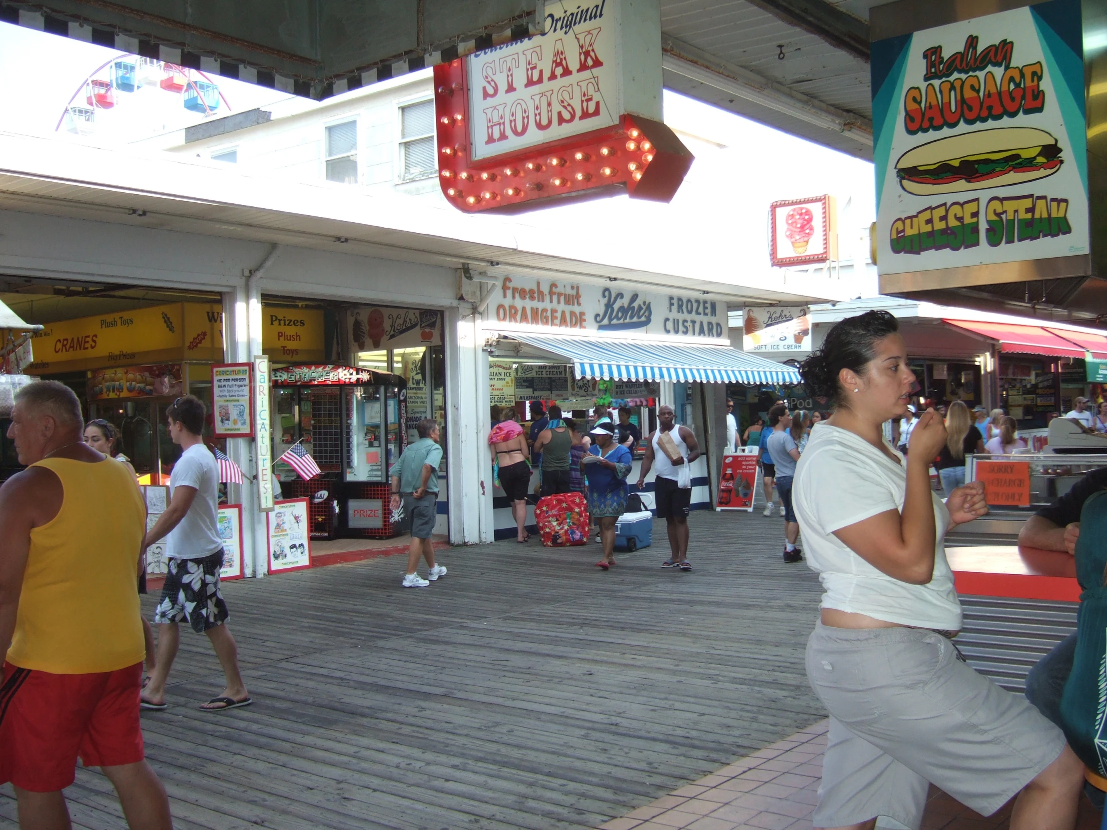 a woman walking down the boardwalk in front of a mcdonald's