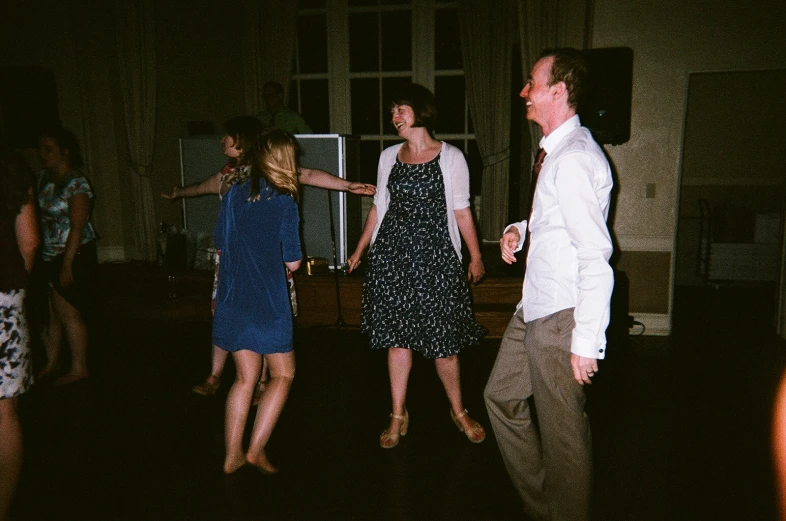 a group of people in a dark room with lights on