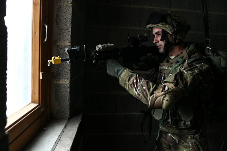 a man in uniform holding a machine gun to his face