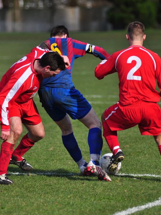 some soccer players are playing a game of soccer