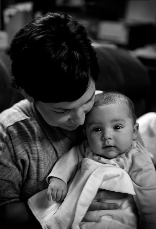 a woman holding a baby on her arm