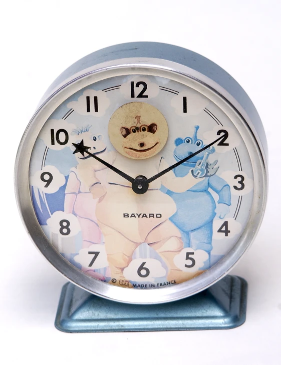 the clock is in blue and white with a bear image