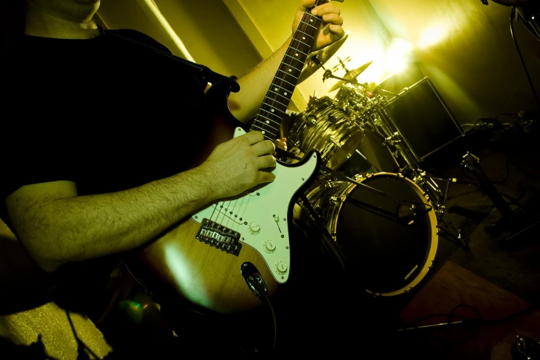 a person playing an electric guitar in a dark room