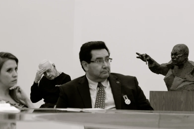 a black and white po of a man and women during a meeting