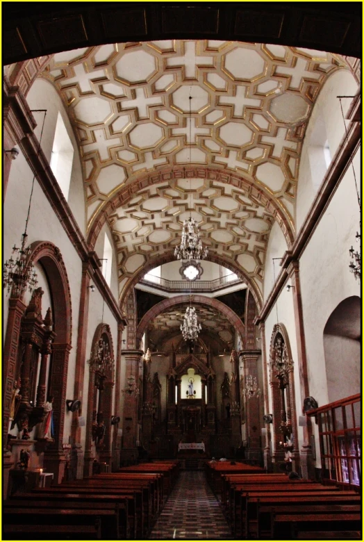 a large church filled with wooden pews under a domed ceiling