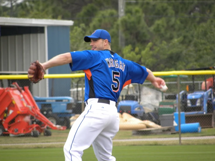 the pitcher in blue jersey is throwing a ball