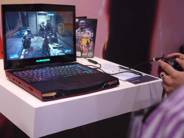 a lap top gaming device sitting on top of a table