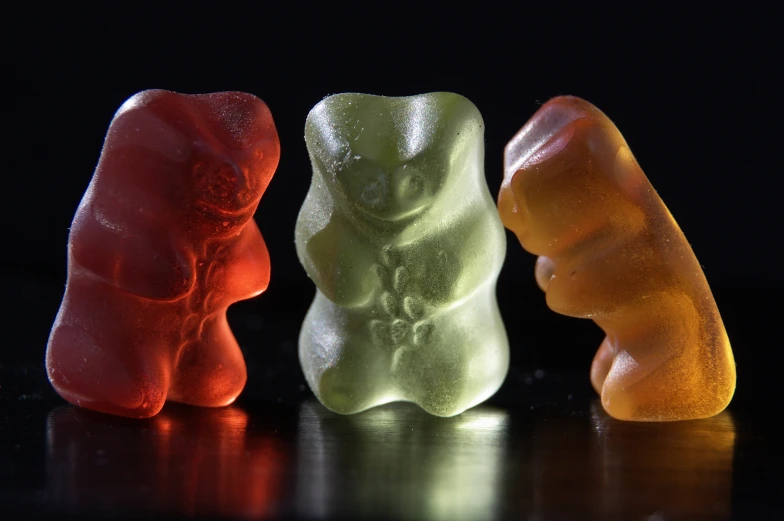 three gummy bears sitting in front of each other