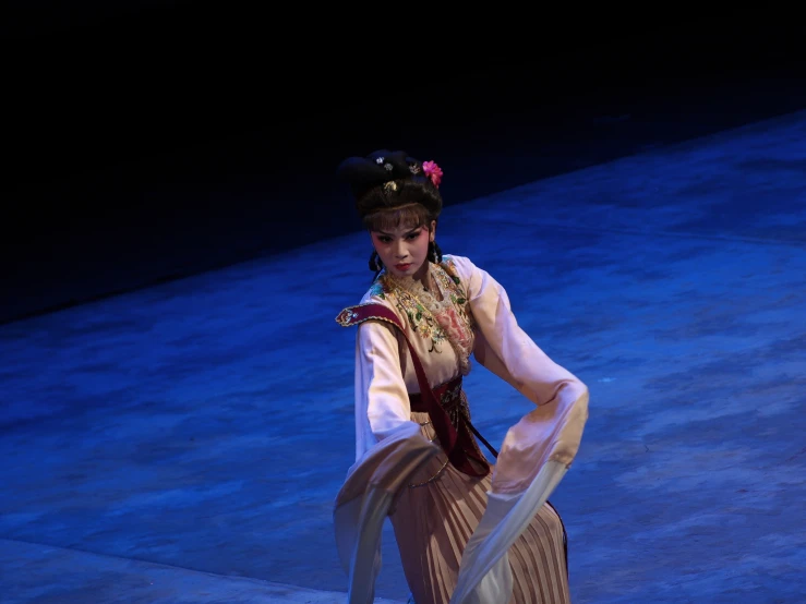 the woman in a geisha suit is holding a large sword