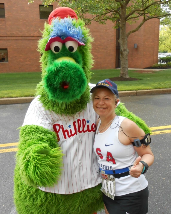 two people wearing matching shirts next to a mascot