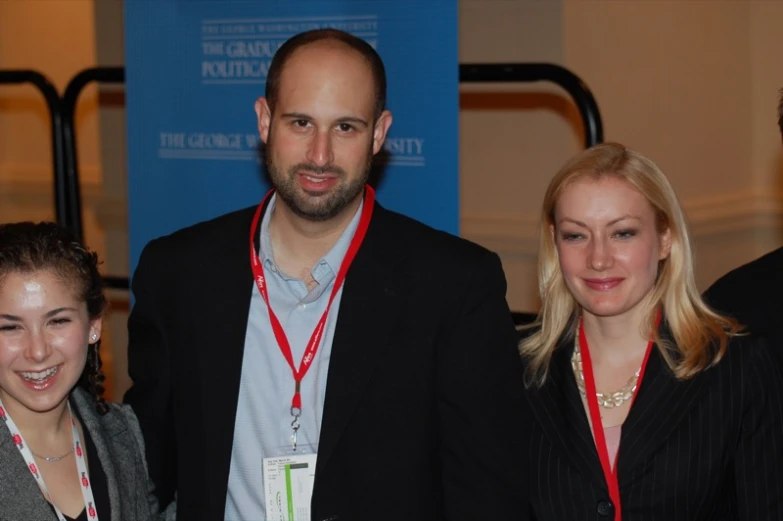 four smiling young people at a conference