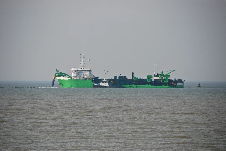 a large green and white boat in the water