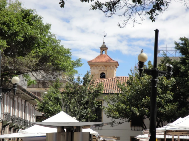 a clock tower above an outdoor market place